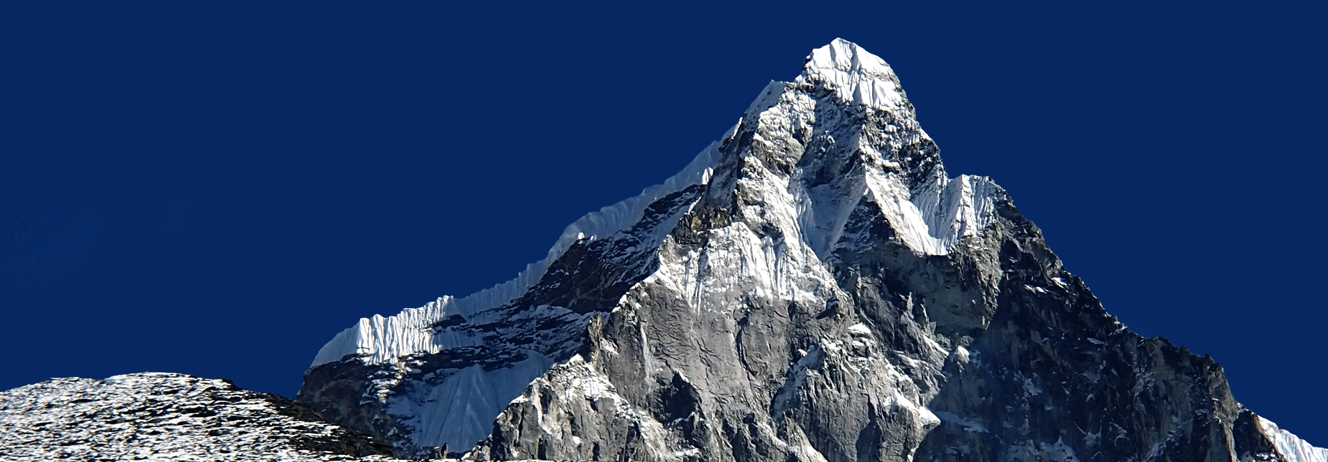 Snowy Himalayan ridge above a trekking trail in Nepal
